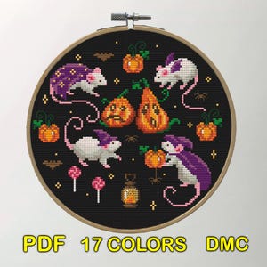 A cross-stitch design featuring white mice with purple capes interacting with pumpkins and other Halloween elements. The background is black, emphasizing the bright colors of the mice and pumpkins.