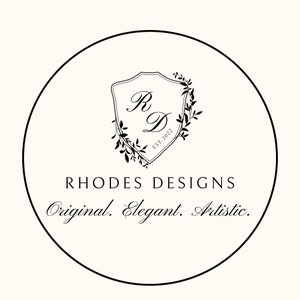 May include: Black and white logo design with a shield featuring the letters "R" and "D" surrounded by a wreath of leaves. The text "Rhodes Designs" is below the shield, and the text "Original. Elegant. Artistic." is below that.