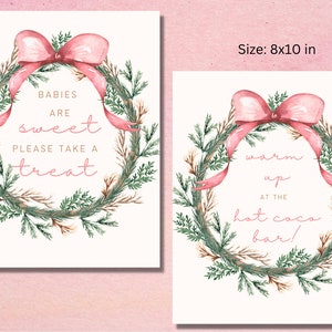 May include: Two printable signs with a watercolor wreath design. The first sign says "Babies are sweet, please take a treat". The second sign says "Warm up at the hot cocoa bar!"
