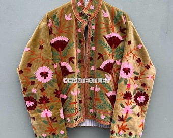 Könnte beinhalten: Senfgelbe Samtjacke mit aufwendiger Blumenstickerei in Rosa, Burgunderrot und Grün. Die Jacke hat einen Stehkragen und den Text "KHANTEXTILE7".