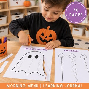 May include: A learning journal with 70 pages featuring Halloween-themed activity sheets. One sheet shows a ghost with a wavy line labeled CUT ALONG THE LINES, and another shows ghosts with various dotted paths labeled CUT THE PATH.