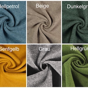 May include: A collection of fabric swatches in various colors, including brown, beige, gray, blue, green, yellow, and purple. The fabric is a soft, fuzzy material.