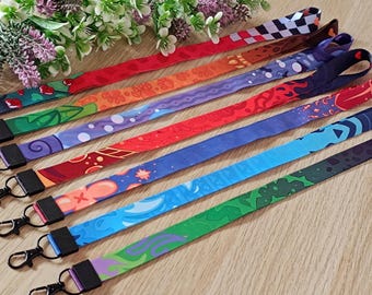 May include: Set of eight colorful patterned lanyards with black metal clasps. The lanyards feature various designs, including geometric patterns, abstract shapes, and floral motifs.