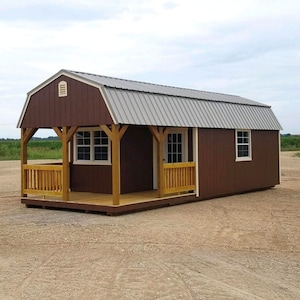 May include: A brown wooden cabin with a grey metal roof and a small porch. The cabin has two windows and a door. The porch has a wooden railing.