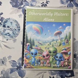 May include: A spiral-bound planner with a cover featuring the text "Otherworldly Visitors: Aliens" and a colorful illustration of aliens and a landscape with flying saucers. A round sticker with the text "MinnieBrick BUDGET" is also visible.
