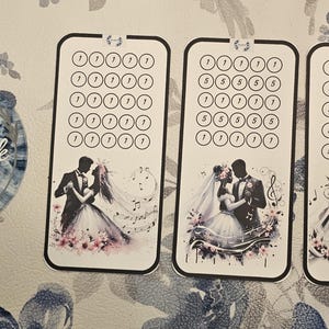 May include: Three white and black wedding-themed budget trackers with a dancing couple illustration. Each tracker has a series of circles for tracking. A round sticker with the text "MinnieBrick BUDGET" is also visible.