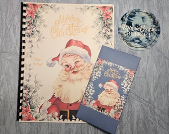 May include: A Christmas budget book with a vintage Santa Claus illustration on the cover. The book has a spiral binding and a blue cover with the text "Merry Christmas" and "Total: $1100".