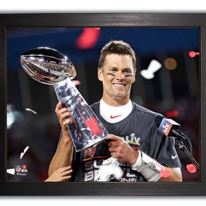 The Tampa Bay Buccaneers Tom Brady Holds The Super Bowl Trophy S.B. LV  Framed 8x10 Photo.