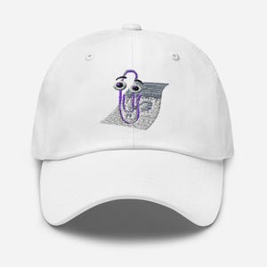 May include: White baseball cap with a curved brim. The cap features an embroidered cartoon paperclip character with purple eyes and a purple paperclip design. The paperclip is holding a stack of papers.
