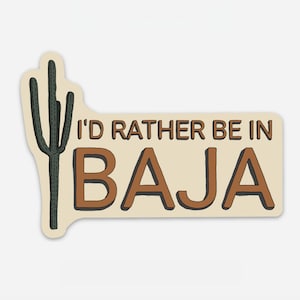 May include: A beige sticker with a brown cactus and the text "I'd rather be in BAJA".