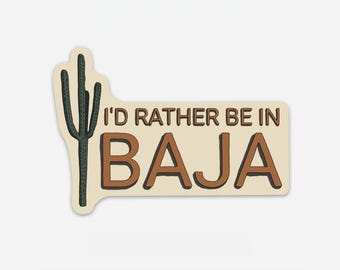 May include: A beige sticker with a brown cactus and the text "I'd rather be in BAJA".