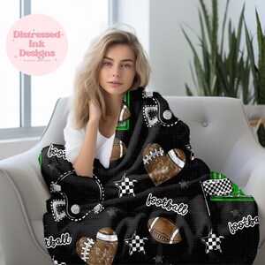 May include: Black fleece blanket with a football theme. The blanket features footballs, helmets, stars, and the word "football" in white. The blanket is decorated with green and white accents.