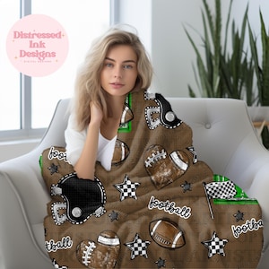 May include: Brown football-themed blanket with a repeating pattern of footballs, helmets, and stars. The blanket has the word "football" printed on it. The blanket is draped over a chair.