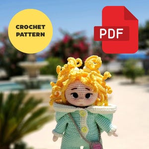 May include: Crocheted doll with yellow hair, wearing a mint green jumpsuit with a small pink purse. The doll has a neutral expression. Text on the image says "CROCHET PATTERN" and "PDF".