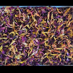 May include: A square container filled with a dense mixture of dried flower petals in shades of deep purple, magenta, and golden yellow. The text B25 is printed in white in the upper left corner of the container, which is filled to the brim.