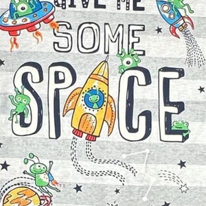 May include: A gray and white striped t-shirt with a space theme. The shirt features the text "Give Me Some Space" with aliens, planets, and rockets.