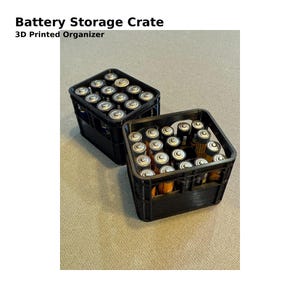 May include: Two black 3D-printed battery storage crates filled with AA and AAA batteries. The text "Battery Storage Crate" and "3D Printed Organizer" are printed at the top of the image.