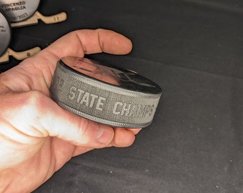 Edge engraved pucks