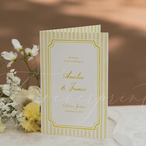 May include: A folded wedding program card featuring a white background with vertical yellow stripes and a yellow decorative border. The text reads Welcome to the wedding of Amelia & James, Lulena Gardens, September 14, 2024, in yellow script and print.