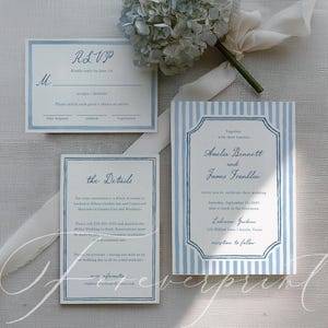 May include: Wedding invitation suite with blue and white striped design. Includes an invitation, RSVP card, and details card. A bouquet of blue hydrangeas and white ribbon are also present.