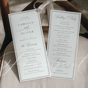 May include: Wedding ceremony programs with elegant calligraphy, listing the wedding party and ceremony details. The programs are on a wooden chair decorated with white flowers and a ribbon. The wedding is for Camilla and Oliver.