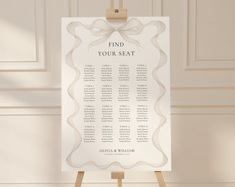 Könnte beinhalten: Ein Hochzeitssitzplan mit einer weißen Schleife und dem Text "Find Your Seat". Der Plan listet die Namen der Gäste nach Tischnummer auf. Am unteren Rand des Plans steht "Olivia & William".