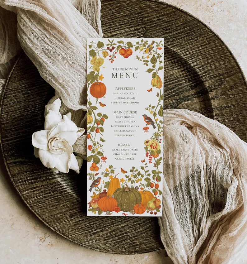 May include: A Thanksgiving menu with a fall-themed design. The menu features a variety of dishes, including shrimp cocktail, Caesar salad, filet mignon, roast chicken, butternut lasagna, grilled salmon, herbed turkey, apple tarte tatin, chocolate cake, and creme brulee.