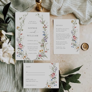 May include: A floral wedding invitation with a white background and a wreath of colorful flowers. The invitation includes the names Sophie and William, the date Saturday, July 14, and the time 1 o'clock in the afternoon. The invitation also includes the location, The Ritz Carlton, 1900 SW 19th Avenue, Miami, FL 33135. The invitation also includes a RSVP card with the text "Joyfully accepts" and "Regretfully declines".
