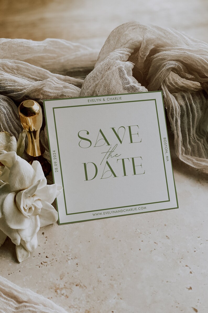 May include: A white save the date card with a green border. The text on the card reads "Save the Date" in a stylized font. The date "28.09.2024" is printed on the left side of the card. The names "Evelyn & Charlie" are printed at the top of the card. The text "Boston, MA" is printed on the right side of the card. The website "www.evelynandcharlie.com" is printed at the bottom of the card.