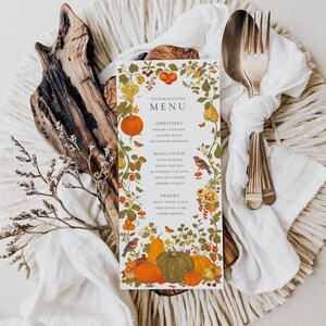 May include: A Thanksgiving menu card with a fall-themed design. The card features pumpkins, gourds, leaves, and birds in shades of orange, yellow, green, and brown. The menu includes appetizers, main courses, and desserts.