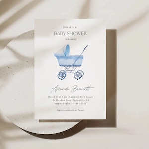 May include: A blue and white baby carriage with a white canopy, watercolor illustration on a white background. The text reads "Join us for a Baby Shower in honor of Amanda Bennett. March 15 at 4 pm | Lavender Brew House 124 Meadow Lane | Springville, CA rsvp to Sophie 333-444-5555 Registry available at Target"