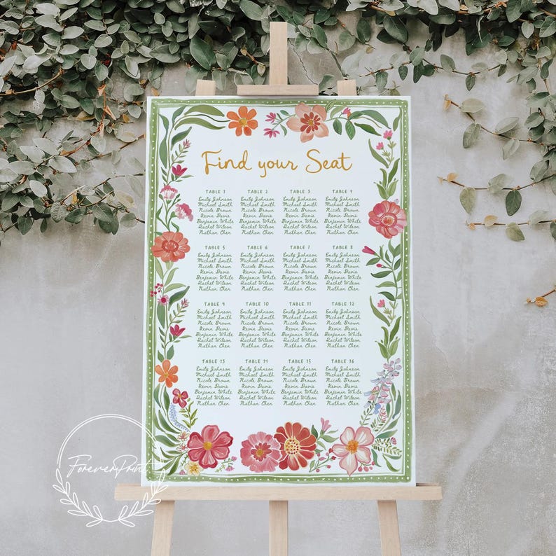 May include: A floral wedding seating chart on an easel. The sign features the words "Find your Seat" in gold script. The border is decorated with watercolor flowers in shades of pink, orange, and green. The names of the guests are listed under each table number.