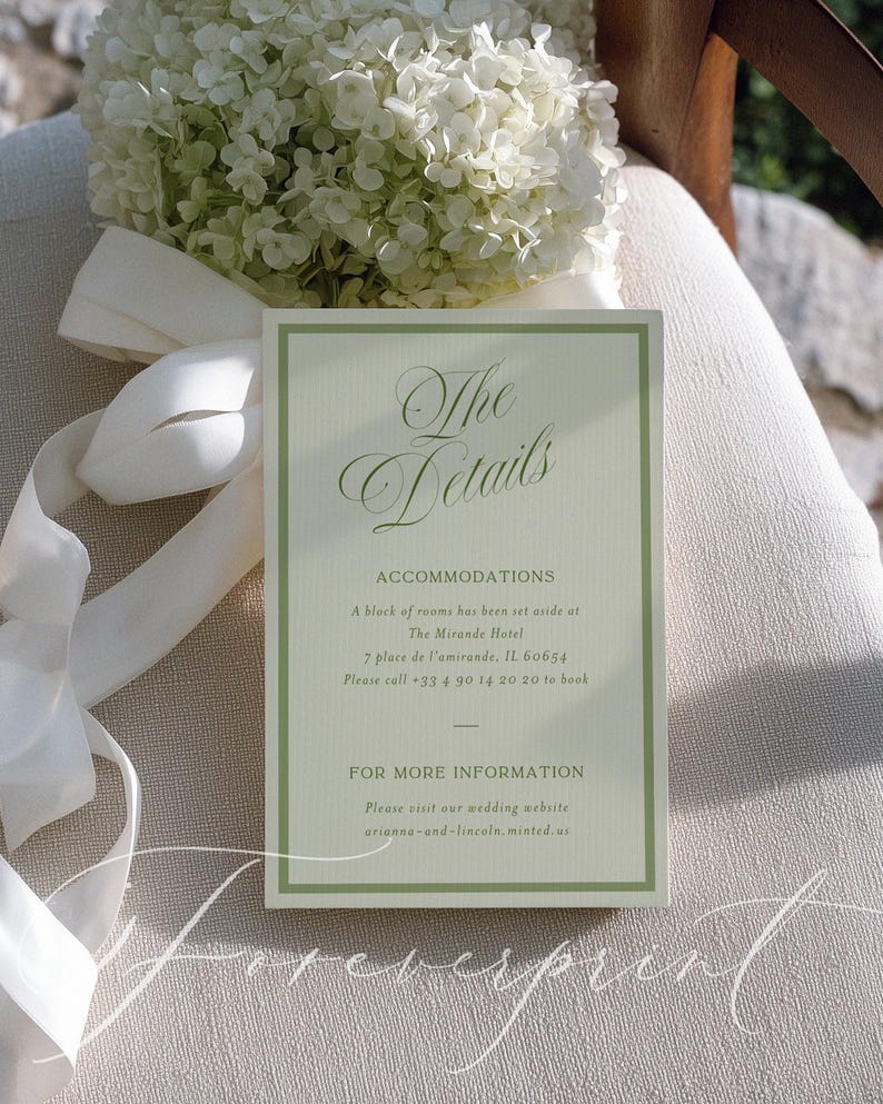 May include: A wedding invitation card with the text "The Details" in elegant script. The card has a light green border and contains accommodation details. A bouquet of white flowers and a white ribbon are in the background.