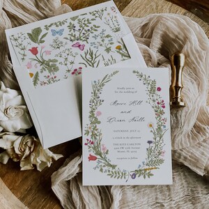 May include: A wedding invitation with a floral wreath border. The invitation is for the wedding of Mauve Hill and Bixen Neelle, on Saturday, July 15th at 2 o'clock in the afternoon at The Ritz Carlton, 3300 SW 17th Avenue, Miami, FL 33155. Reception to follow.