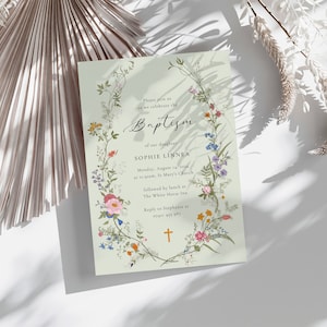 May include: A light green baptism invitation with a floral wreath border. The text reads "Please join us as we celebrate the Baptism of our daughter Sophie Linnea. Monday, August 14, 2024 at 10:00am, St. Mary's Church, followed by lunch at The White House Inn. Reply to Stephanie at 0741 431 987."
