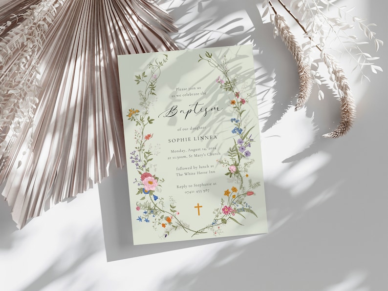 May include: A light green baptism invitation with a floral wreath border. The text reads "Please join us as we celebrate the Baptism of our daughter Sophie Linnea. Monday, August 14, 2024 at 10:00am, St. Mary's Church, followed by lunch at The White House Inn. Reply to Stephanie at 0741 431 987."