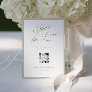以下が含まれることがあります： 「Share the Love」と書かれたエレガントな筆記体の結婚式の招待状。カードにはQRコードと、Scarlett & Lincolnの名前と日付が記載されています。カードは薄い緑色の縁取りで、花の背景が施されています。