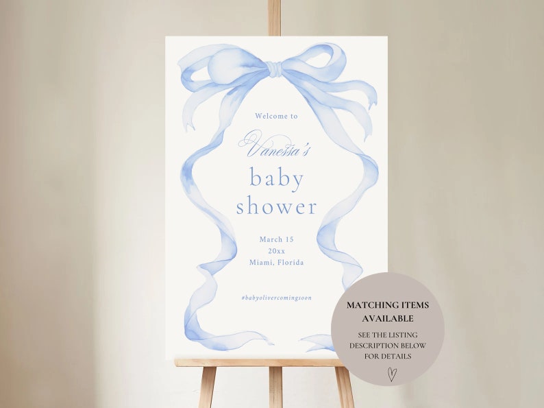 May include: A blue watercolor ribbon bow with a white background. The text reads "Welcome to Vanessa's baby shower March 15 20xx Miami, Florida #babyolivercomingsoon".