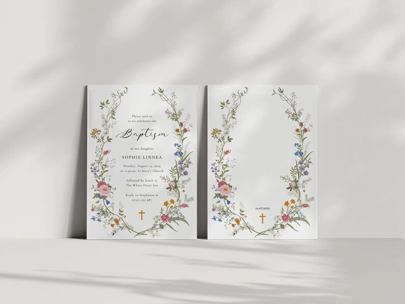 May include: A floral baptism invitation with a wreath of colorful flowers and greenery. The text reads "Please join us as we celebrate the Baptism of our daughter Sophie Linnea Monday, August 15, 2022 at 11:00 am St. Mary's Church followed by lunch at The White Horse Inn Reply to Stephanie by August 1st"