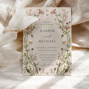 May include: Wedding invitation with floral border featuring a botanical illustration of wildflowers and butterflies. The invitation is for the wedding of Harper and Michael, taking place on Saturday, October 28th at 3 o'clock in the afternoon at The Ritz Carlton, 1300 SW 27th Avenue, Miami, FL 33155.