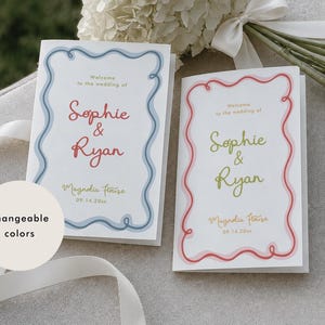May include: Two white wedding programmes with a wavy border design. The left programme features blue borders and red text reading Welcome to the wedding of Sophie & Ryan, Magnolia House, 09.14.20xx. The right programme has red borders and green text.