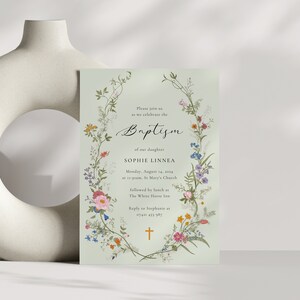 May include: A green floral baptism invitation with a cross at the bottom. The invitation reads "Please join us as we celebrate the Baptism of our daughter Sophie Linnea. Monday, August 14, 2014 at 11:00am, St. Mary's Church followed by lunch at The White Horse Inn. Reply to Stephanie at 07481 453 987."