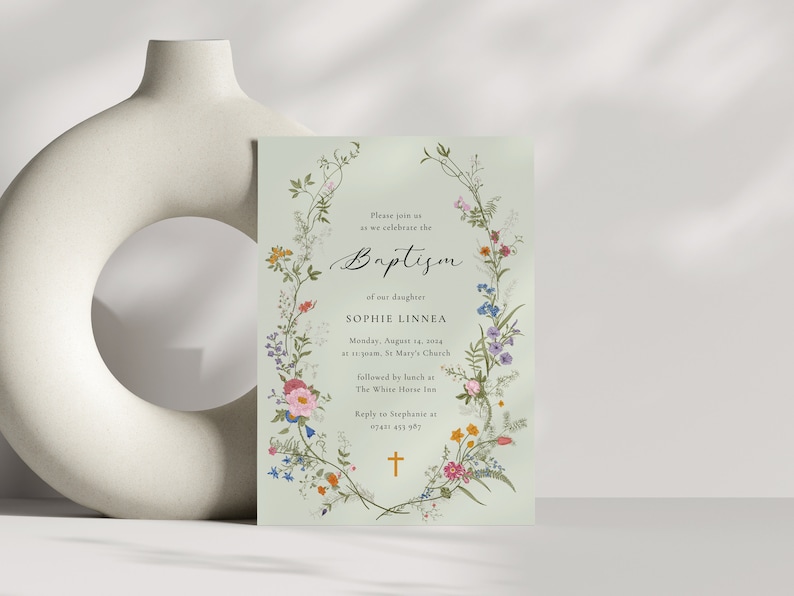 May include: A green floral baptism invitation with a cross at the bottom. The invitation reads "Please join us as we celebrate the Baptism of our daughter Sophie Linnea. Monday, August 14, 2014 at 11:00am, St. Mary's Church followed by lunch at The White Horse Inn. Reply to Stephanie at 07481 453 987."