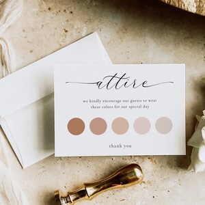 May include: A white card with the word "attire" written in cursive. The card also includes the text "we kindly encourage our guests to wear these colors for our special day" and a row of five color swatches in shades of pink and brown. The card ends with the text "thank you".
