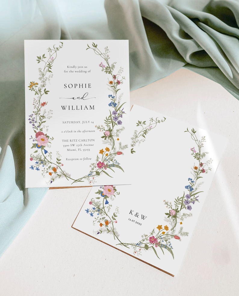 May include: Wedding invitation with a floral design. The invitation is white with black text. The text reads "Kindly join us for the wedding of Sophie and William, Saturday, July 14, 2 o'clock in the afternoon, The Ritz Carlton, 3300 SW 17th Avenue, Miami, FL 33155, Reception to follow". The invitation is surrounded by a wreath of flowers in shades of pink, purple, blue, yellow, and green.