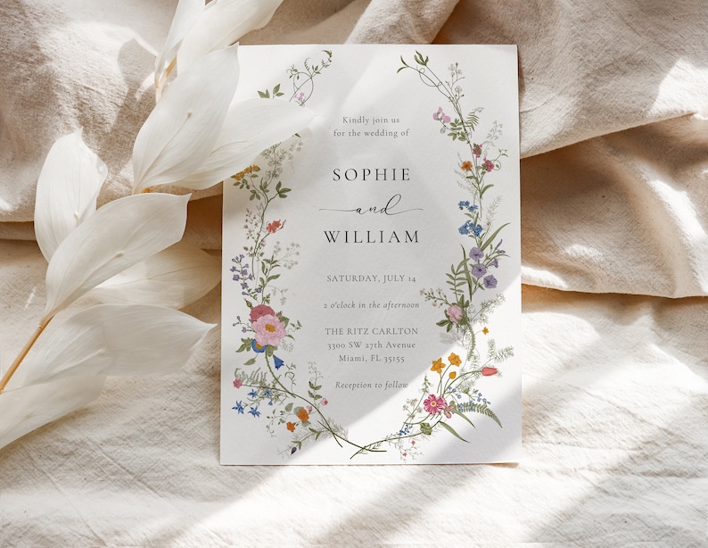 May include: Wedding invitation with a floral border. The invitation is for Sophie and William, and it states the wedding will be held on Saturday, July 14 at 2 o'clock in the afternoon at The Ritz Carlton in Miami, Florida.