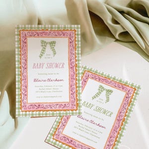 May include: Two baby shower invitations with a pink and green gingham border. The invitations have a pink frame with floral and bow accents. Text includes "Baby Shower" and event details.
