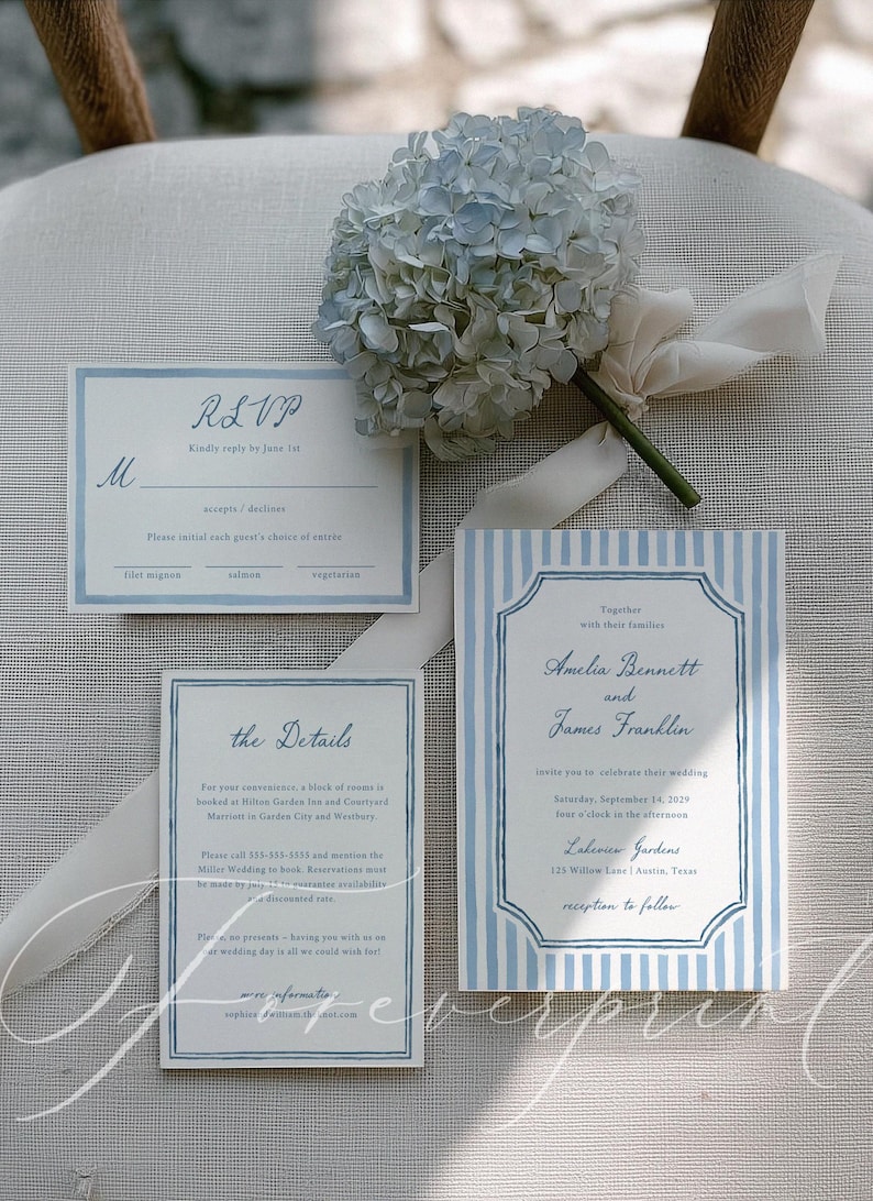 May include: Wedding invitation suite with blue and white striped design. Includes an invitation, RSVP card, and details card. A bouquet of blue hydrangeas and white ribbon are also present.