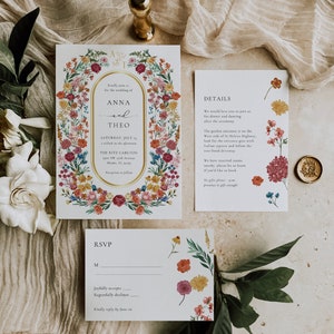 May include: A wedding invitation suite with floral designs. The invitation features a gold frame with the names Anna and Theo, the date, and the location. The RSVP card has a floral design and a space for guests to indicate their attendance.