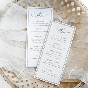 May include: Two elegant menu cards with black text on a white background. The menus feature a detailed list of courses, including an amuse-bouche, starter, main course, cheese course, and dessert. The cards are set in a woven basket.